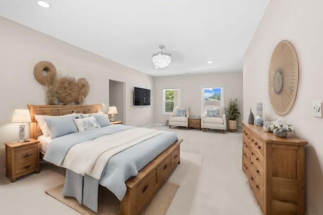 bedroom with an inviting chandelier, recessed lighting, and light colored carpet