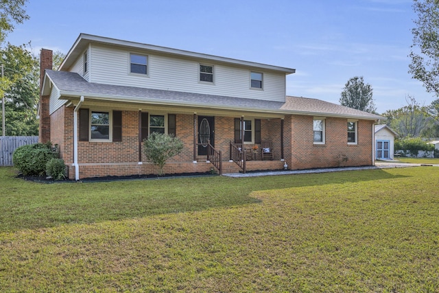 view of front facade with a front lawn and covered porch