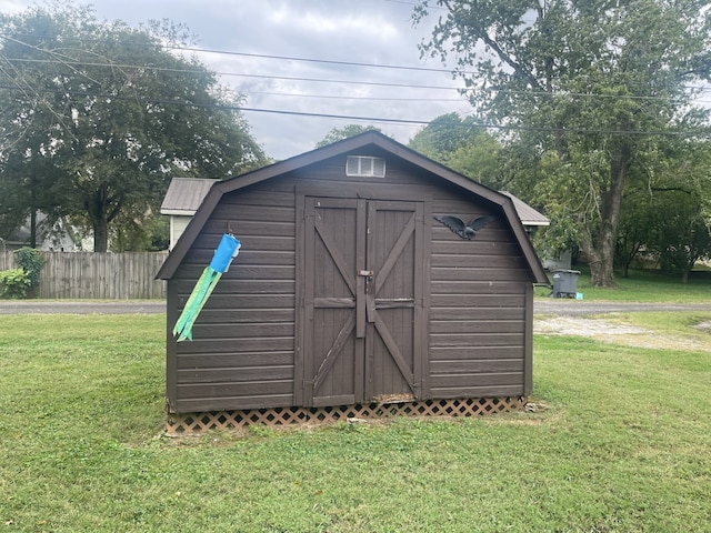 view of shed featuring fence