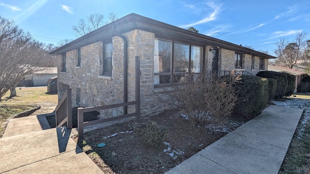 view of property exterior with stone siding