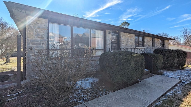 view of property exterior with stone siding