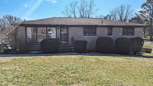 single story home featuring a shingled roof, stone siding, and a front lawn