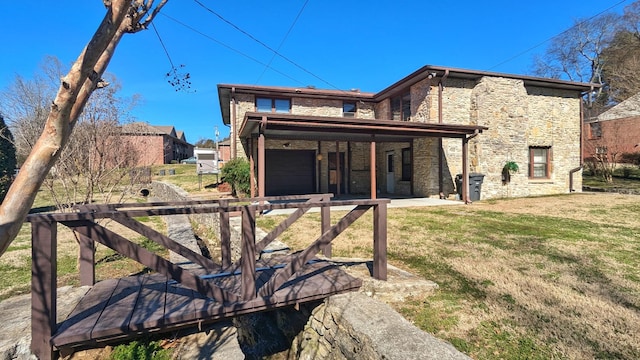 back of house featuring stone siding and a lawn