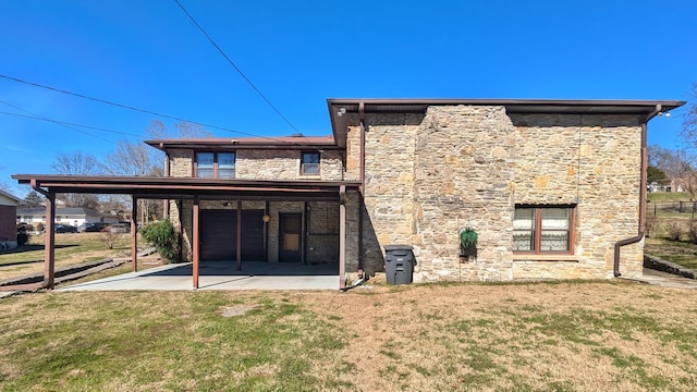 rear view of property featuring stone siding and a yard