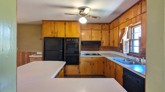 kitchen featuring brown cabinetry, light countertops, a sink, and black appliances