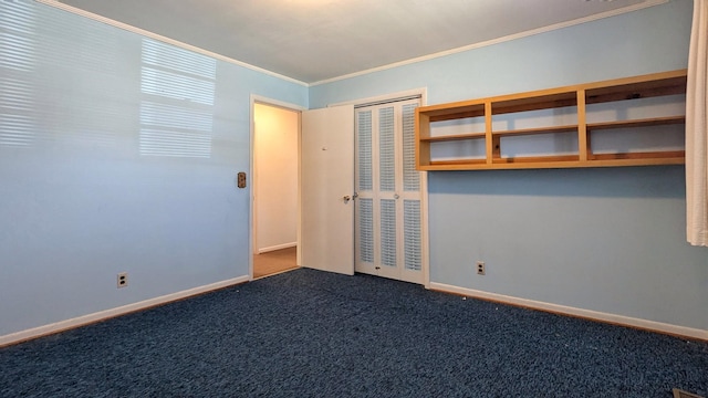 empty room with carpet, ornamental molding, and baseboards