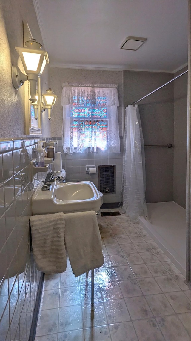 full bathroom with crown molding, a stall shower, tile walls, and tile patterned floors