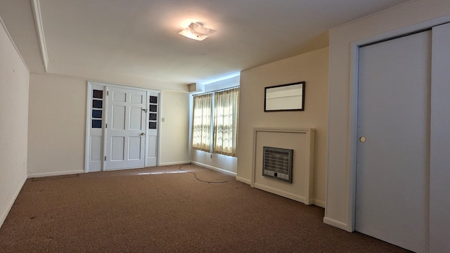 carpeted entrance foyer featuring baseboards