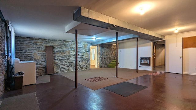 finished basement featuring heating unit, washer / dryer, and stairs