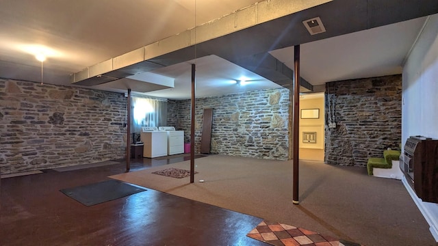 basement with washing machine and clothes dryer and heating unit