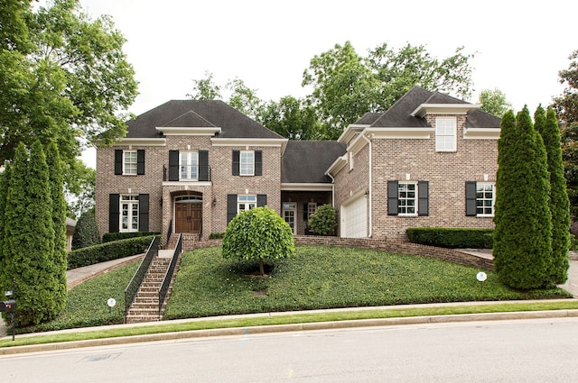 view of front facade with a garage and a front lawn