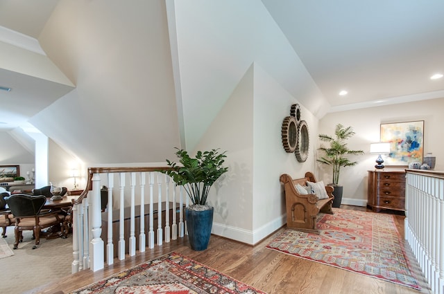 corridor featuring vaulted ceiling and hardwood / wood-style floors