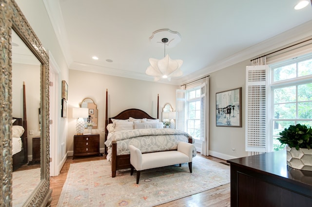 bedroom featuring crown molding and light hardwood / wood-style floors