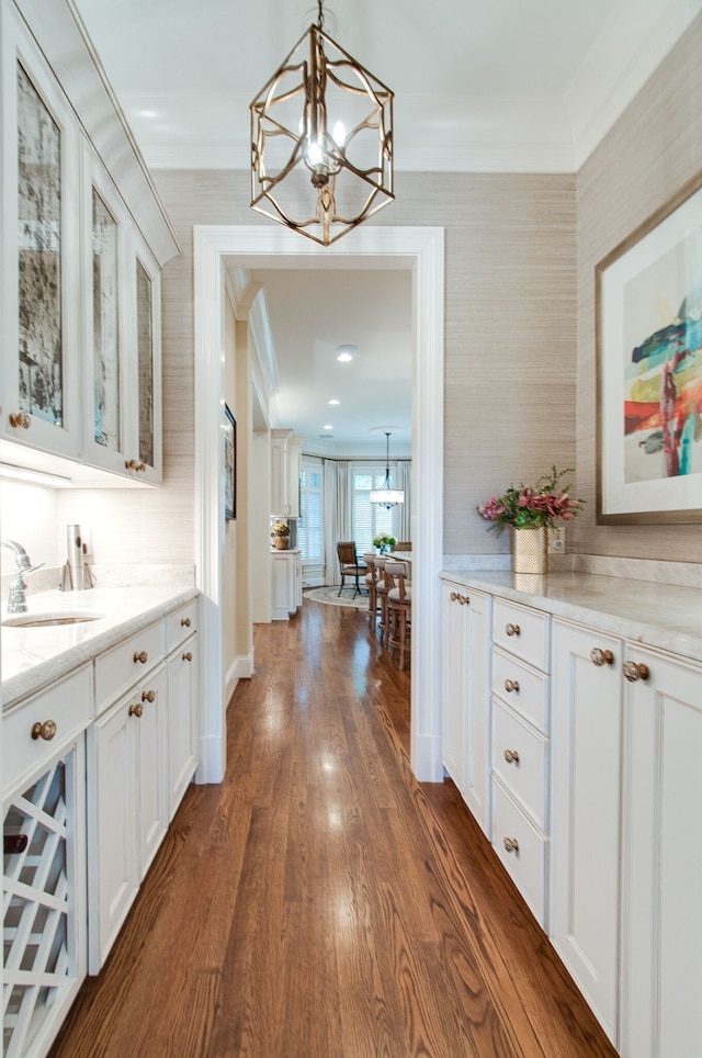 interior space featuring dark hardwood / wood-style flooring, sink, and white cabinets