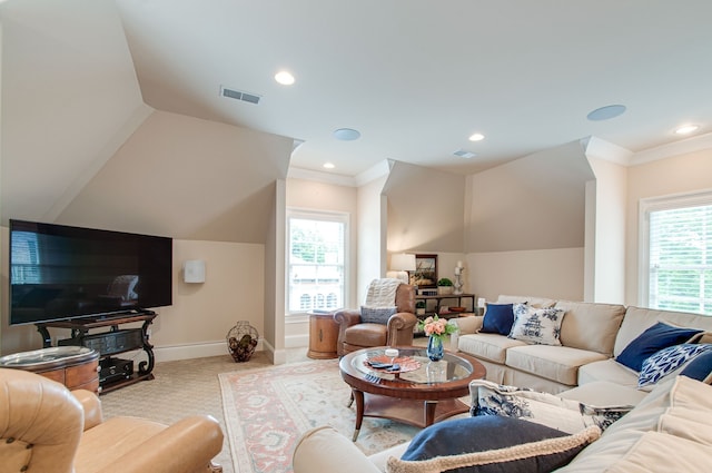 carpeted living room with a wealth of natural light and ornamental molding