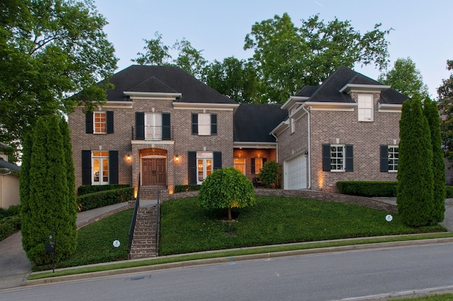 colonial inspired home with a front lawn