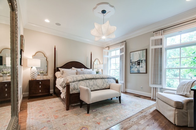 bedroom featuring ornamental molding and light hardwood / wood-style flooring