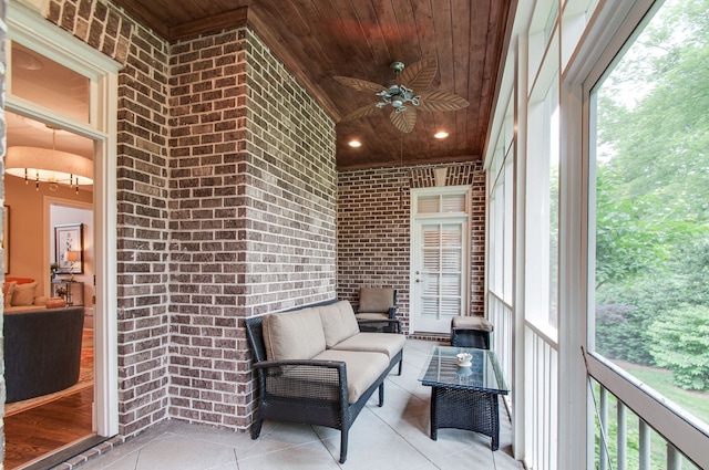 unfurnished sunroom with ceiling fan, plenty of natural light, and wooden ceiling