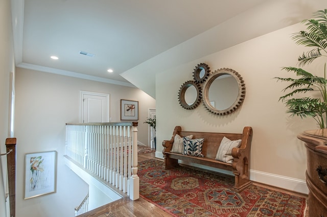 corridor with crown molding and hardwood / wood-style flooring