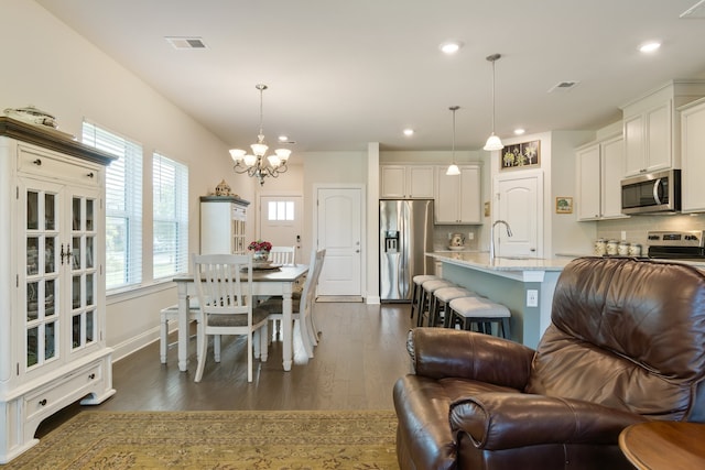 interior space with sink, a chandelier, and dark hardwood / wood-style flooring