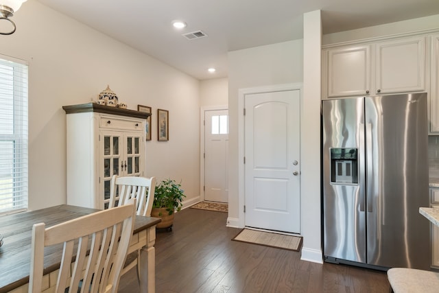 kitchen with white cabinetry, plenty of natural light, dark hardwood / wood-style flooring, and stainless steel refrigerator with ice dispenser