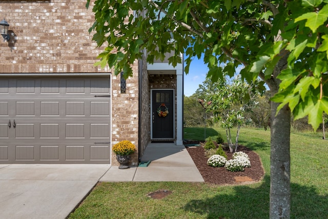 doorway to property with a yard and a garage