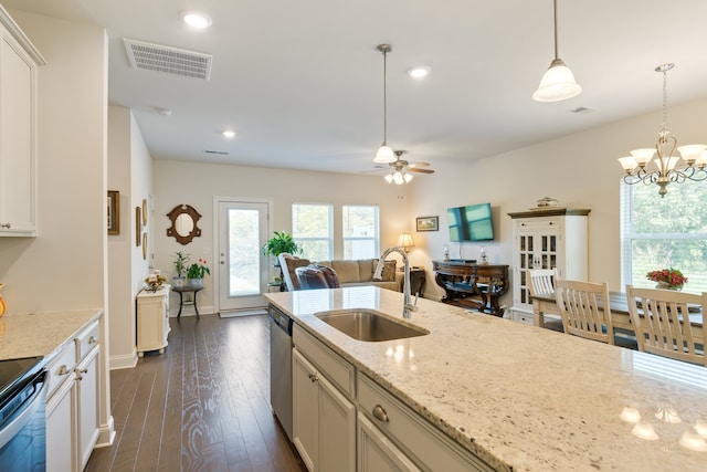 kitchen featuring ceiling fan with notable chandelier, decorative light fixtures, light stone counters, sink, and dark hardwood / wood-style floors