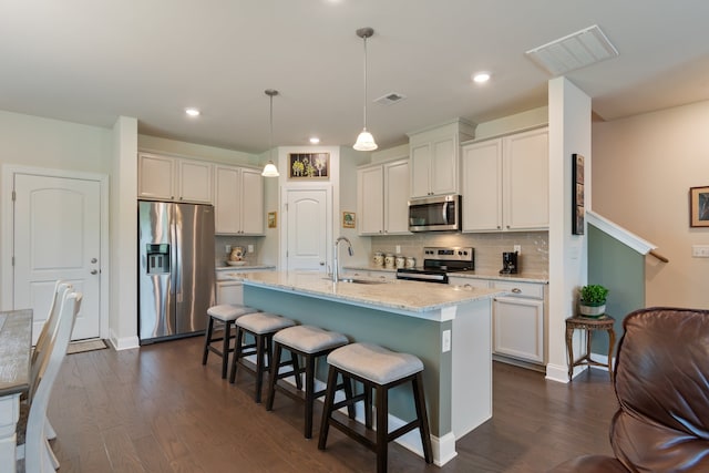 kitchen with decorative light fixtures, stainless steel appliances, dark hardwood / wood-style flooring, and sink