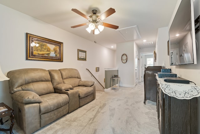 carpeted living room with ceiling fan