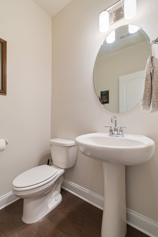 bathroom featuring hardwood / wood-style floors and toilet