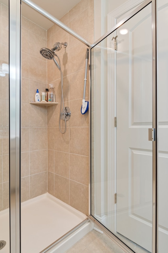 bathroom featuring tile patterned flooring and a shower with door