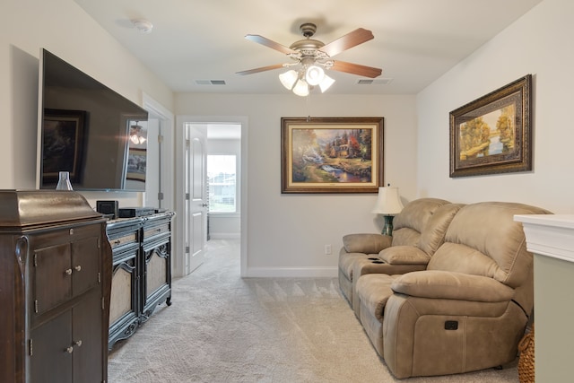 interior space with light carpet and ceiling fan