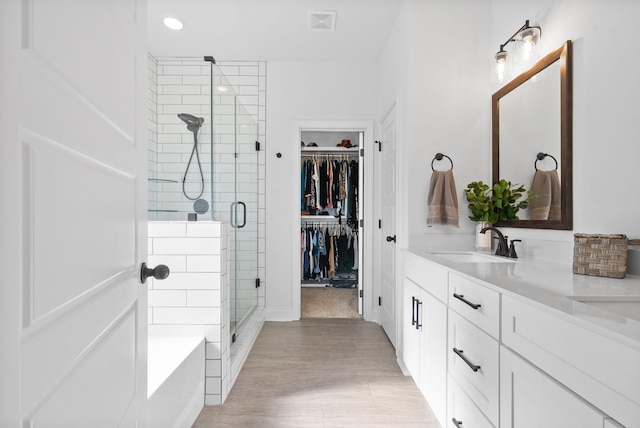 bathroom featuring vanity and separate shower and tub