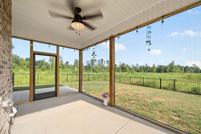 unfurnished sunroom with ceiling fan and a healthy amount of sunlight