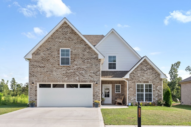 view of property with a front yard and a garage