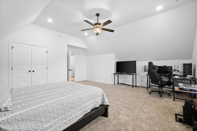 bedroom featuring lofted ceiling, carpet flooring, ceiling fan, and a closet