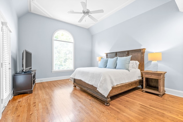 bedroom with light wood-type flooring, baseboards, ceiling fan, and vaulted ceiling