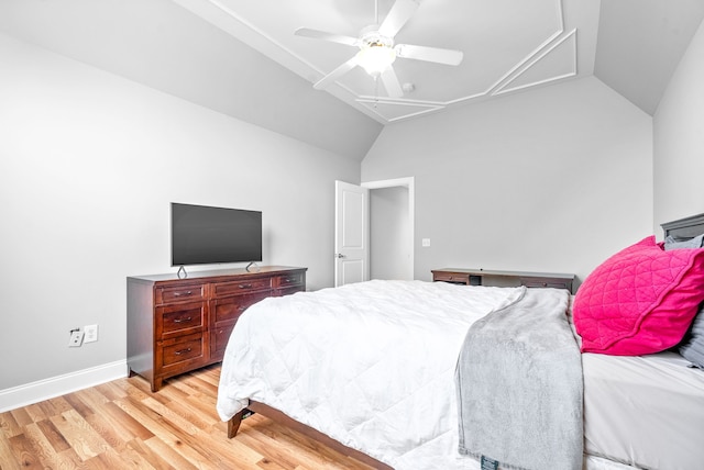 bedroom featuring a ceiling fan, baseboards, attic access, vaulted ceiling, and light wood-style floors