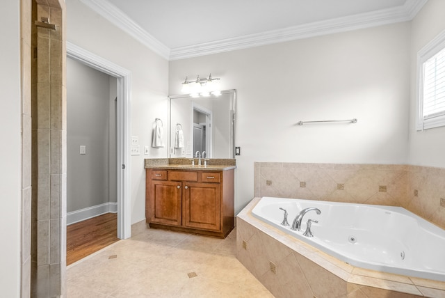 bathroom with vanity, tile patterned floors, a tub with jets, and ornamental molding