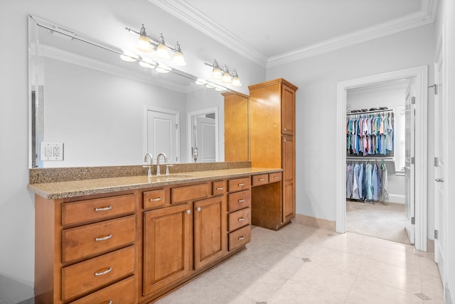 bathroom featuring vanity, baseboards, tile patterned flooring, a spacious closet, and crown molding