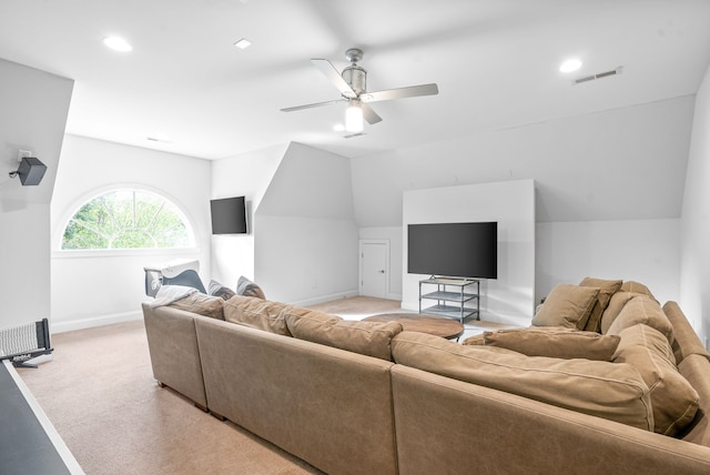 living room featuring a ceiling fan, baseboards, visible vents, vaulted ceiling, and light carpet