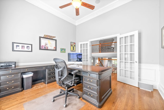 home office featuring a ceiling fan, wood finished floors, wainscoting, and ornamental molding