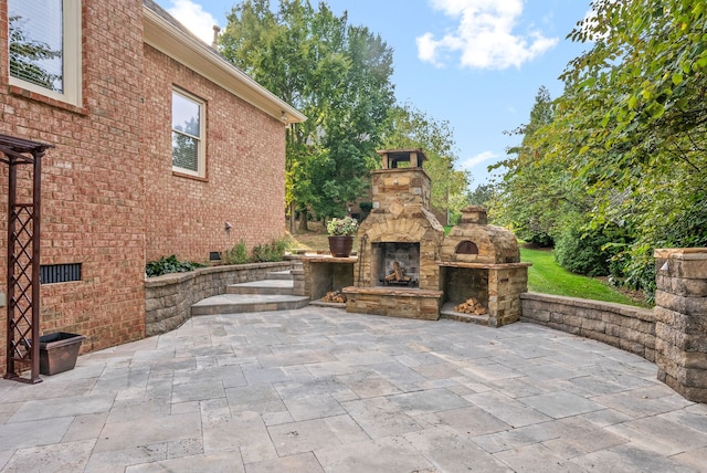 view of patio / terrace with an outdoor stone fireplace