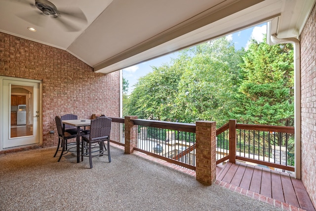 wooden terrace featuring outdoor dining space and ceiling fan