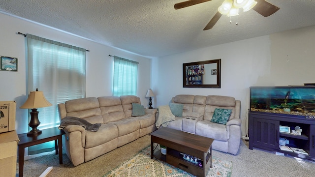 carpeted living room with ceiling fan and a textured ceiling