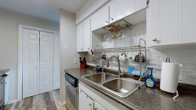 kitchen with light wood-type flooring, white cabinetry, sink, decorative backsplash, and stainless steel dishwasher