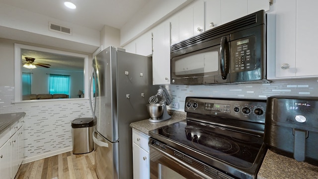 kitchen with light wood-type flooring, tasteful backsplash, black appliances, ceiling fan, and white cabinets