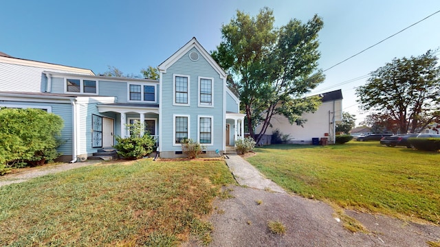 view of front facade featuring a front yard and central AC unit