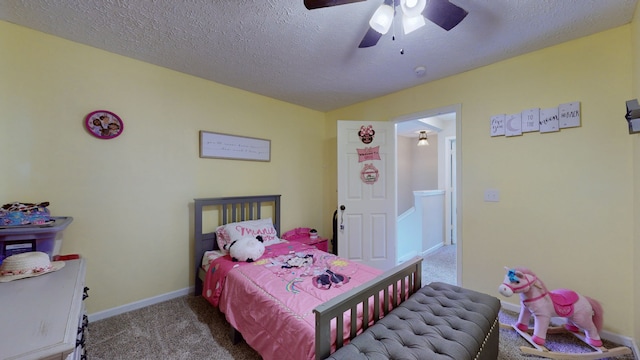 bedroom featuring a textured ceiling, ceiling fan, and carpet floors