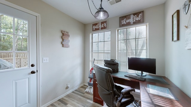 office space with light wood-type flooring